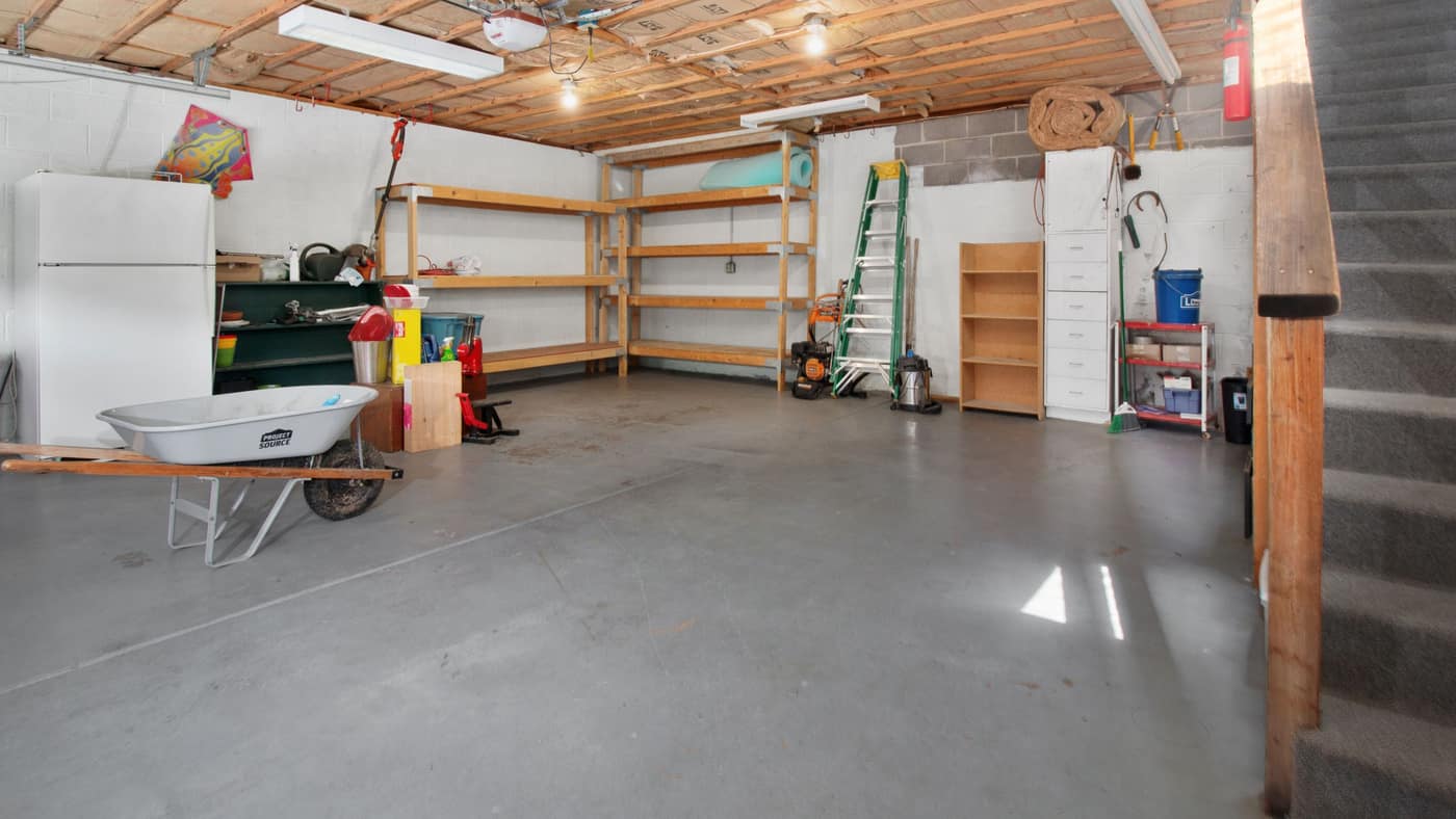 An empty garage with a swept concrete floor.